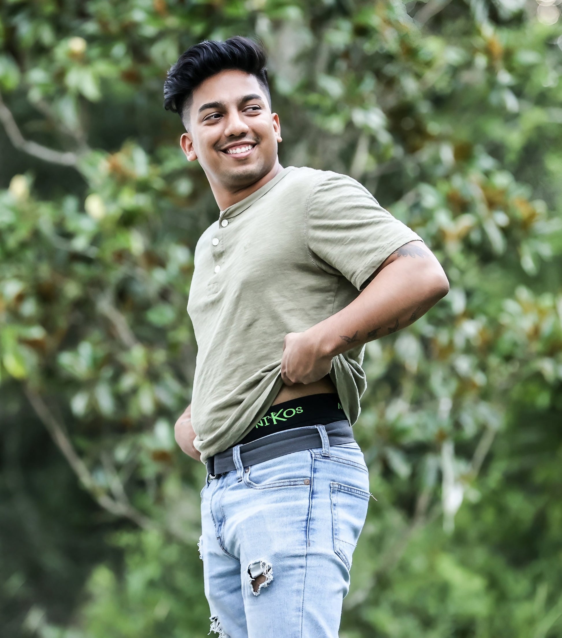 Young man adjusting his Nikos Bamboo Boxer Briefs